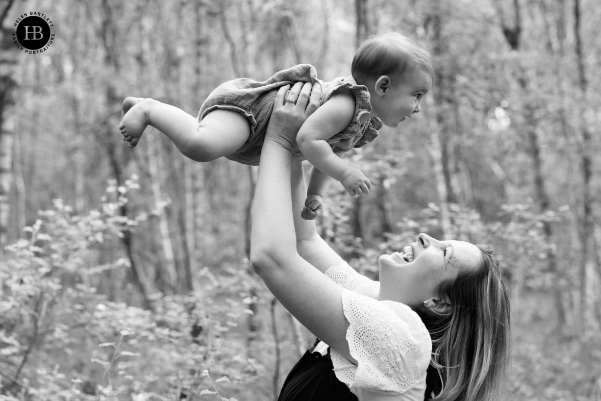 mum-holds-laughing-baby-in-air