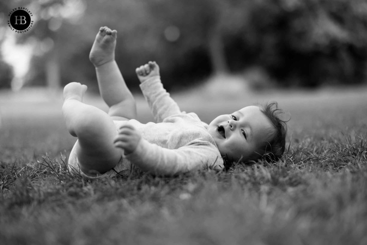 laughing-baby-lying-on-grass-primrose-hill-north-london