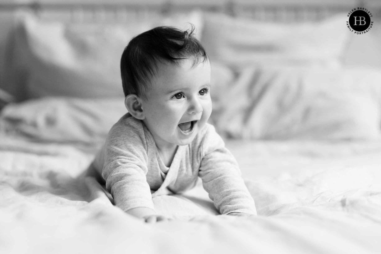 laughing-baby-photographed-on-bed