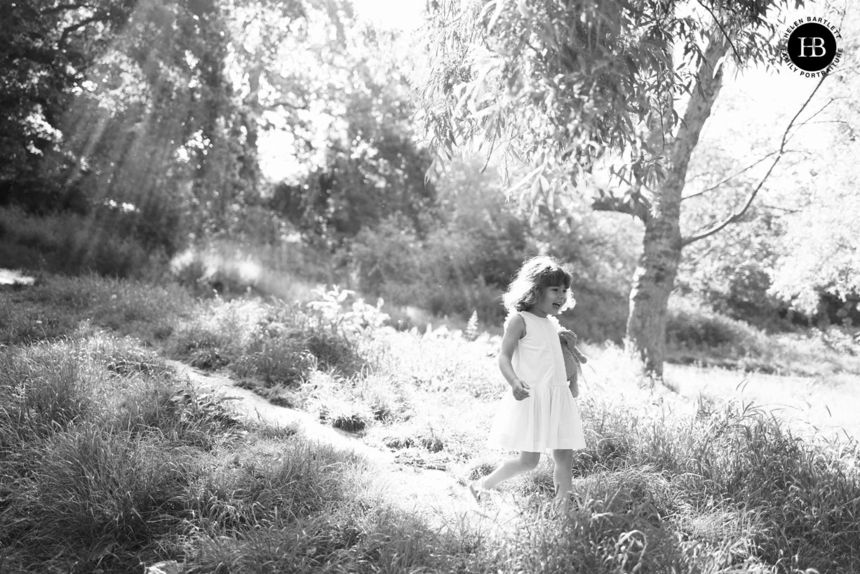 little-girl-in-white-dress-in-beams-of-sunlight