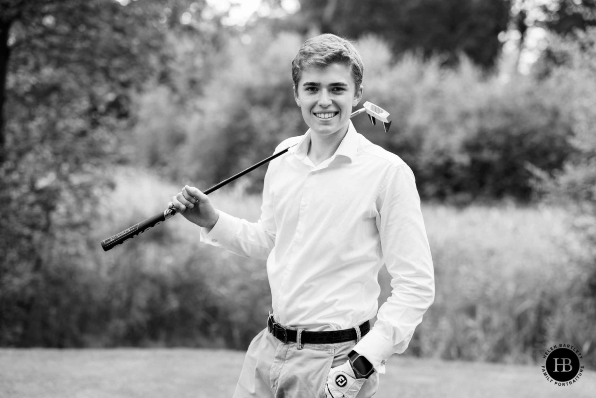 smiling-young-man-with-golf-club-portrait