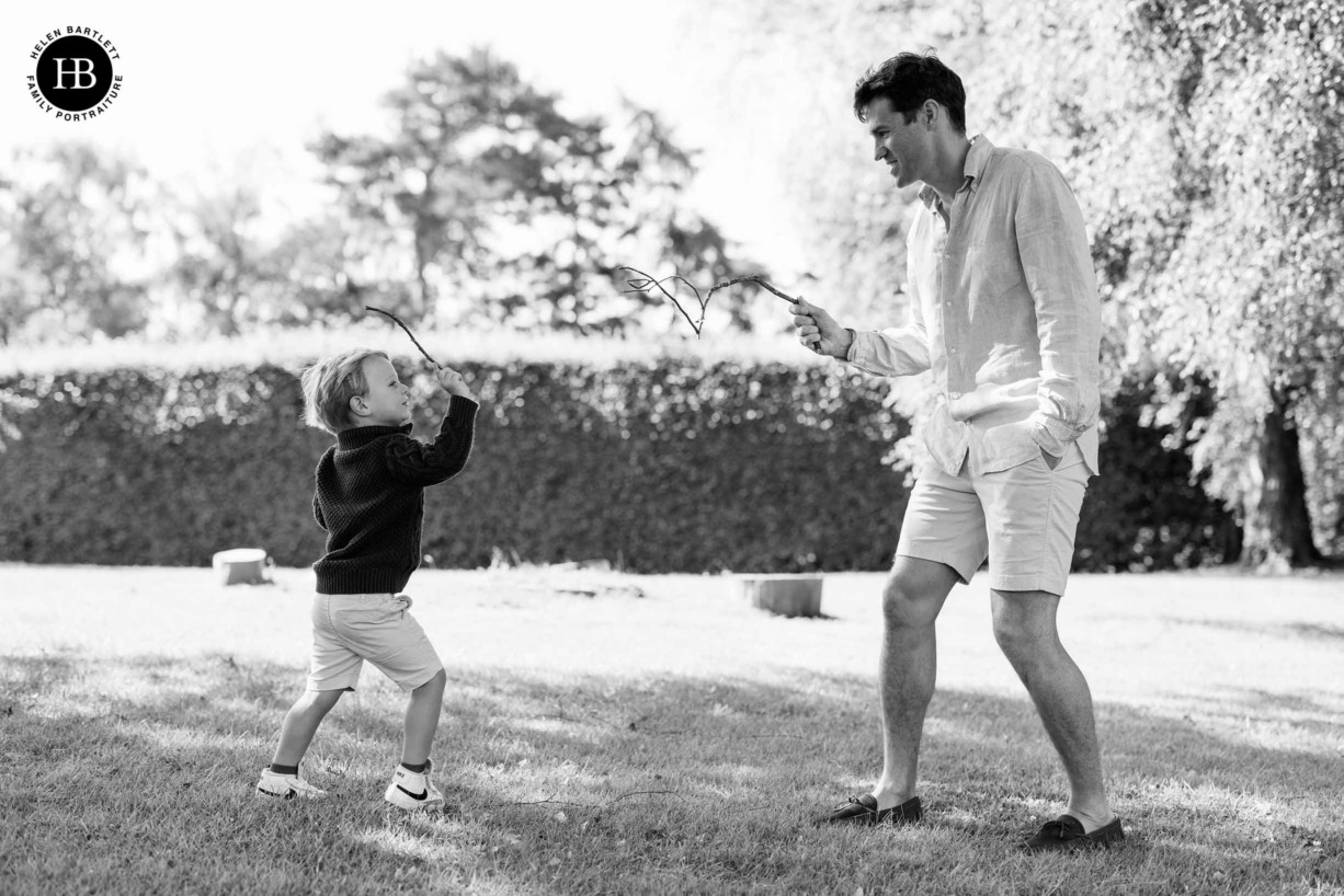 child-and-dad-fence-with-sticks