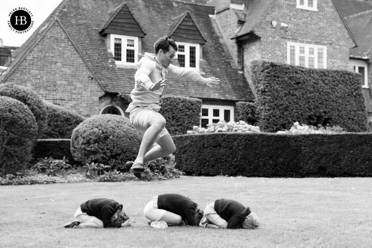 dad-leaps-over-children-in-garden-game