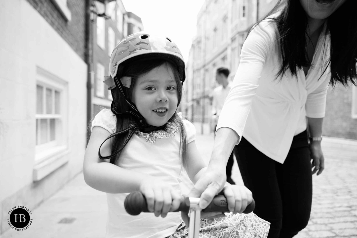 little-girl-on-scooter-helped-by-mum