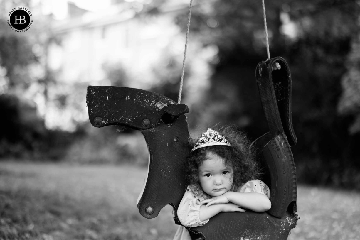 tired-little-girl-leans-on-rope-swing