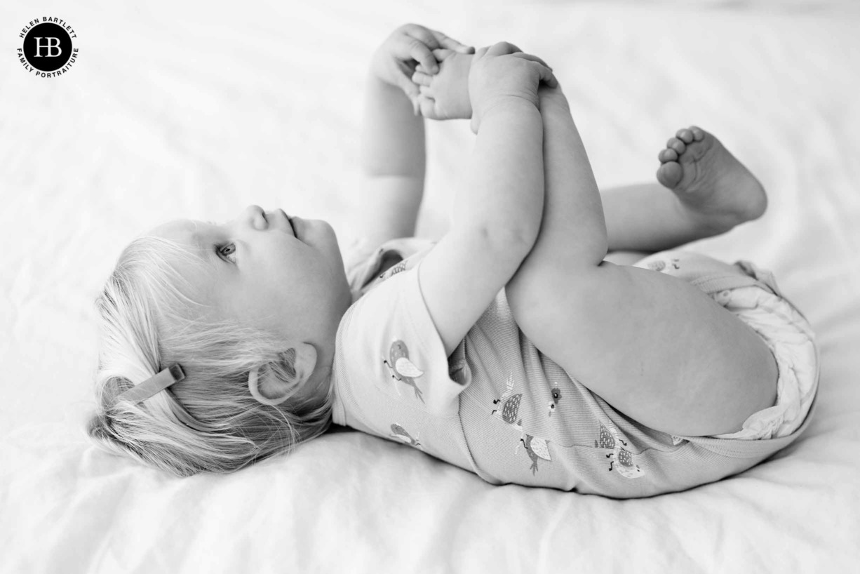 baby-on-bed-holding-toes