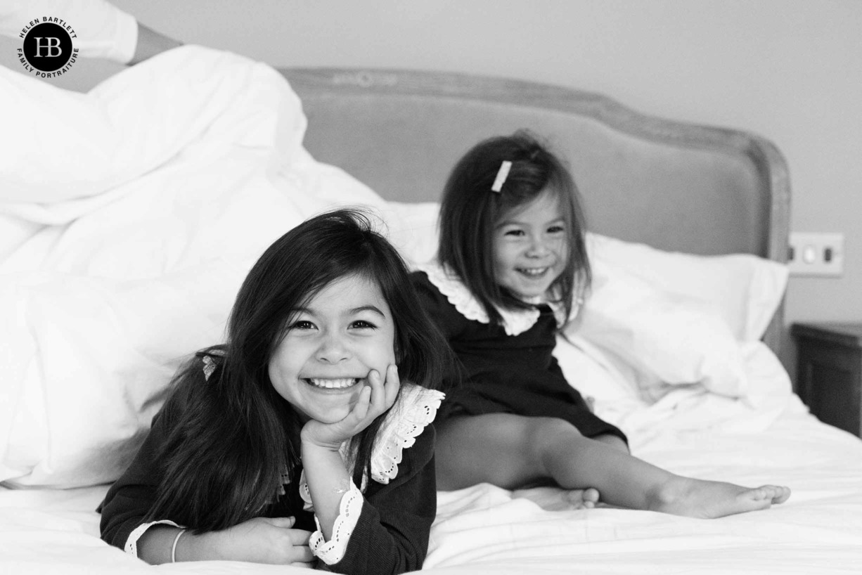 girls-laugh-on-bed-during-family-photo-shoot-south-west-london