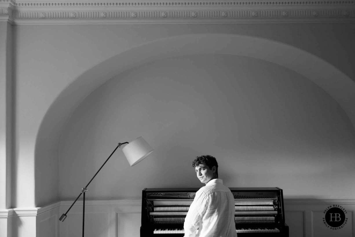 teenage-boy-looks-round-sat-at-piano