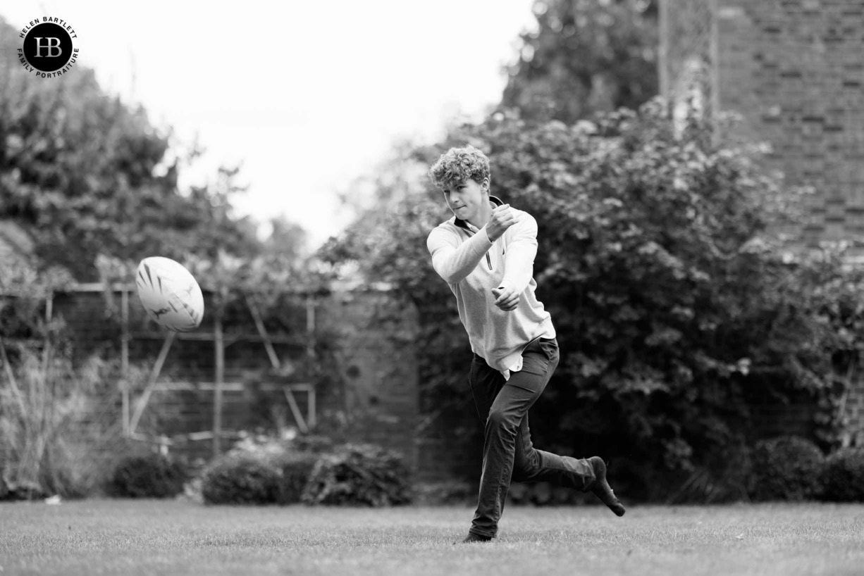 teenager-throws-rugby-ball-on-activity-led-family-photo-shoot