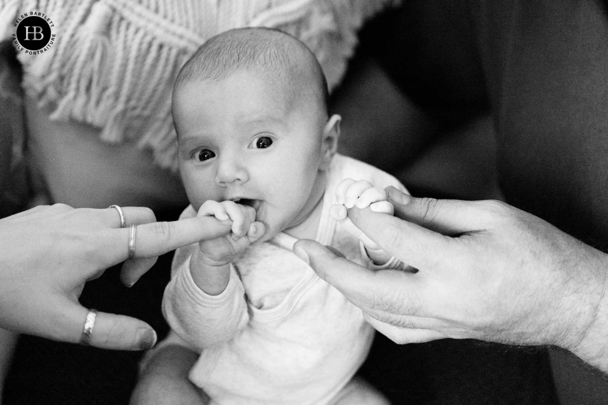 baby-holds-parents-fingers-newborn-photoshoot-ha