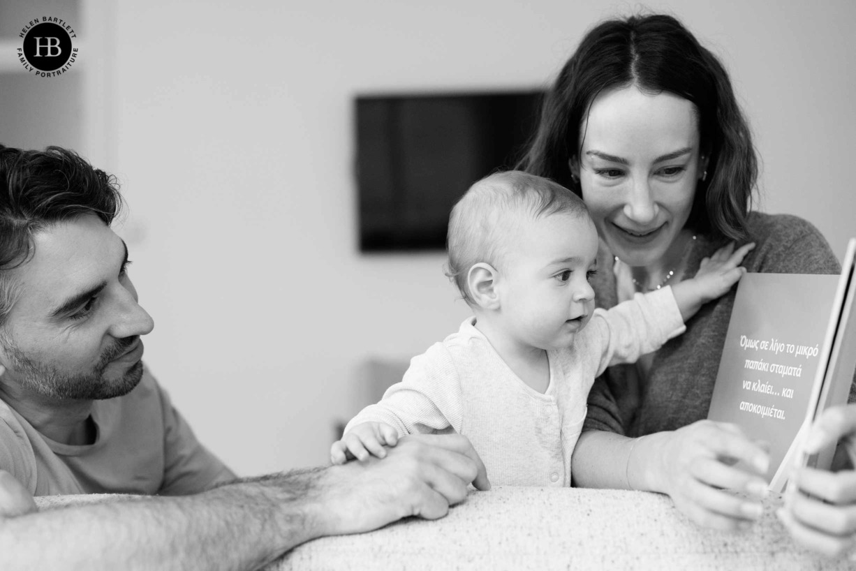 family-baby-reading-book-on-family-photo-shoot