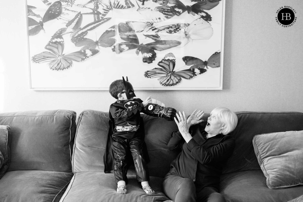 little-boy-dressed-as-batman-plays-with-grandmother