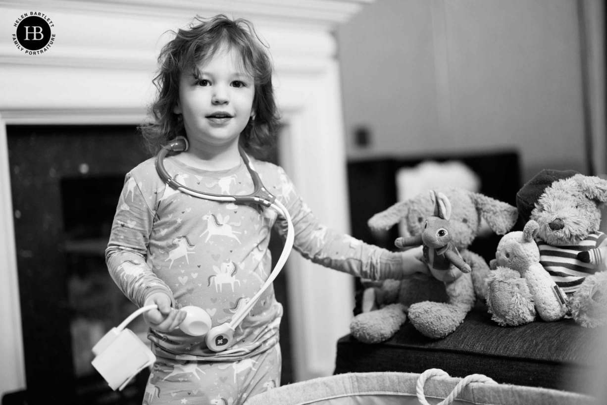 little-girl-playing-doctor-with-toy