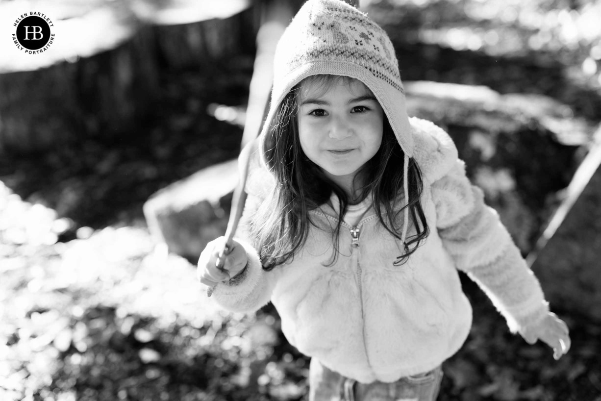 little-girl-playing-with-stick-on-family-photo-shoot-chiswick-w4