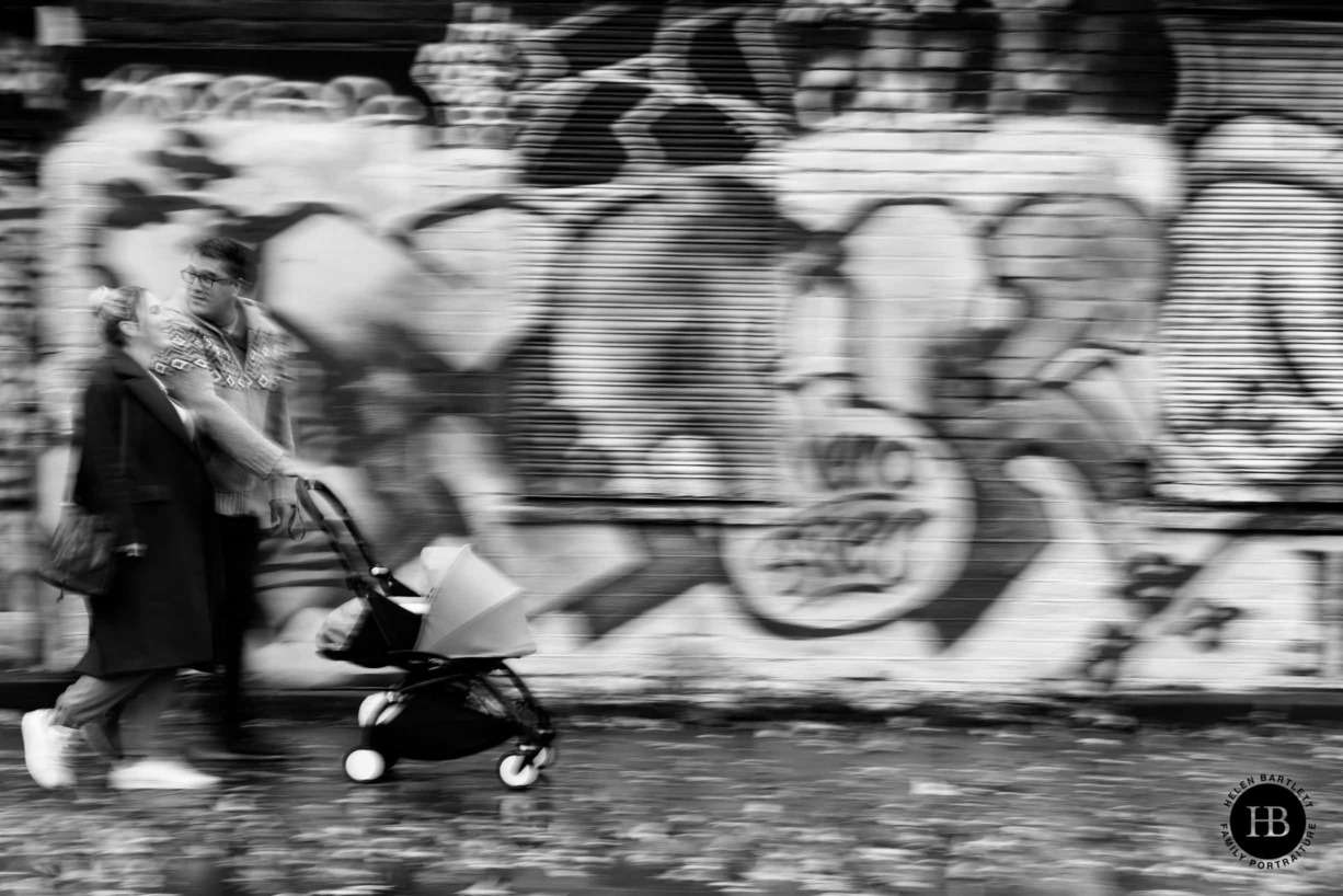 panned-shot-to-show-movement-family-walk-east-london-graffiti