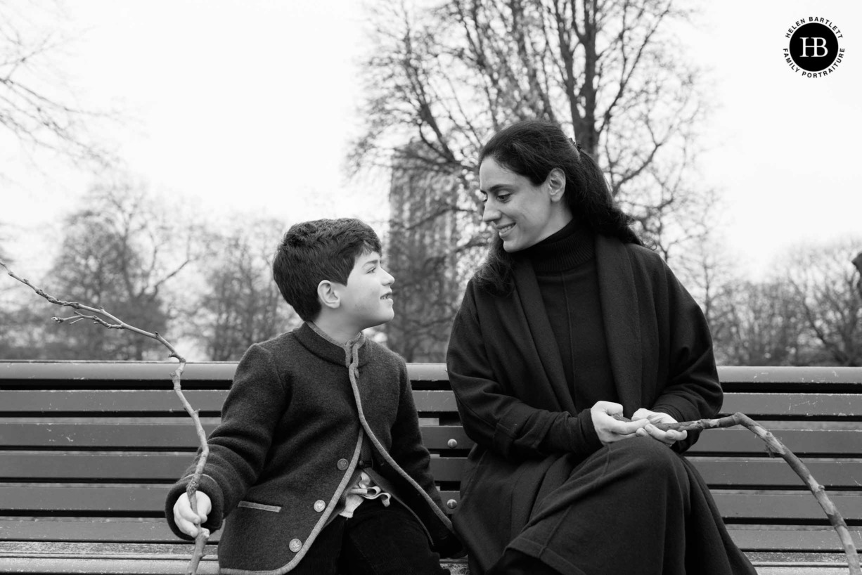 mother-and-son-share-moment-while-sitting-on-bench-hyde-park