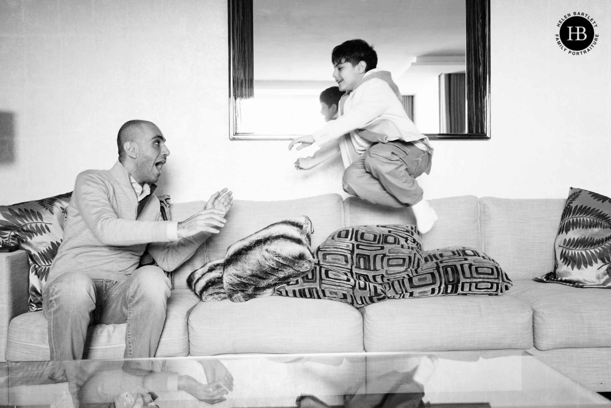 boy-jumps-on-sofa-during-family-photo-shoot-belgravia