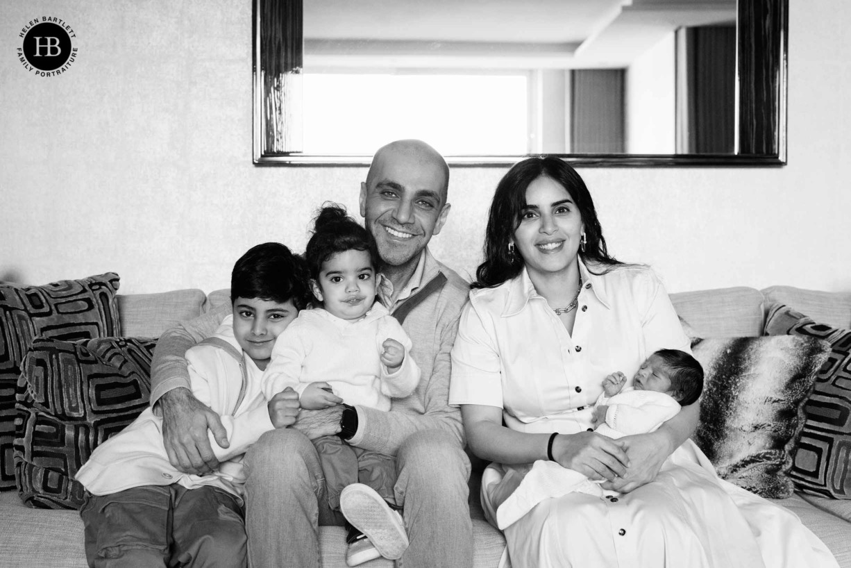 family-portrait-on-sofa-with-newborn