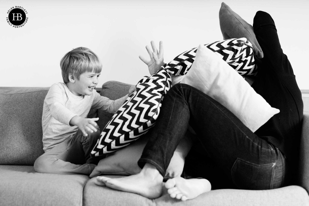 father-son-play-pillow-fight-on-professional-family-photo-shoot